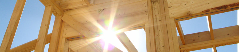 Photo - sunlight shining through house framing